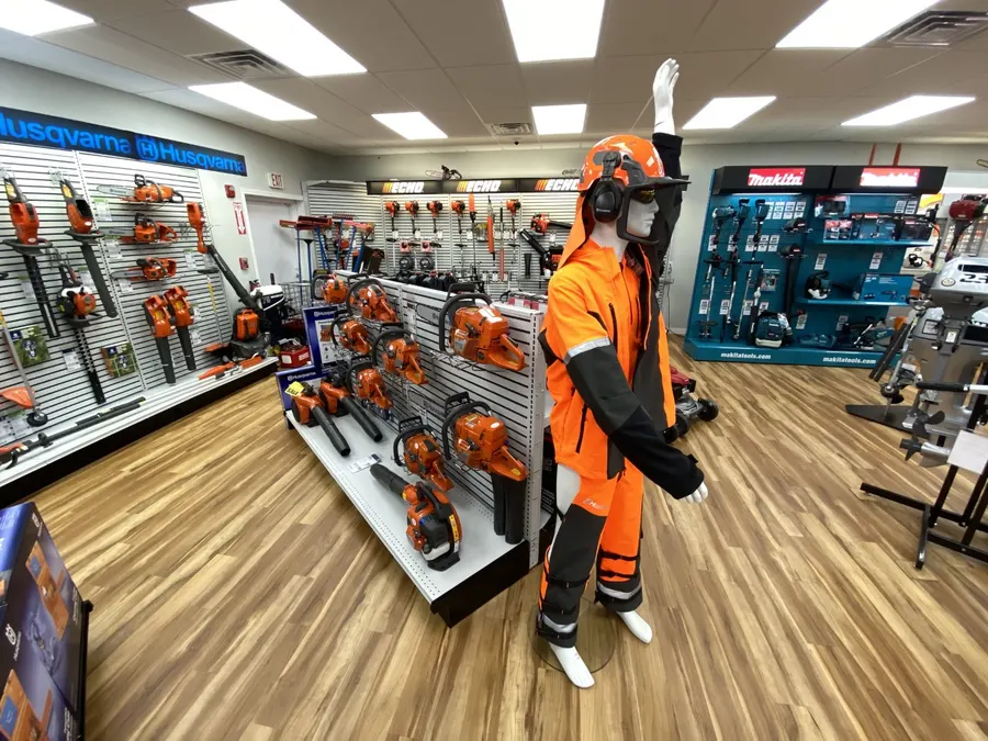 Chainsaws and outdoor gear on the showroom wall